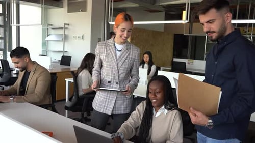 Company of multiethnic colleagues working together in office