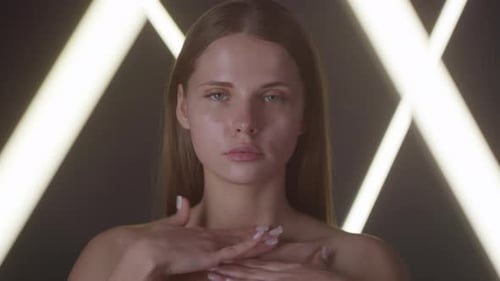 Woman Applies Lotion to Neck and Chest