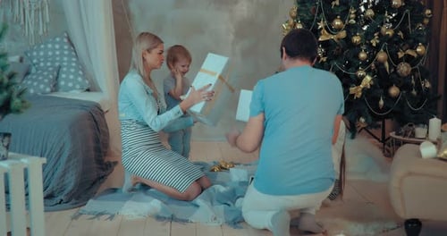 Festive Family Opens Christmas Presents at Home