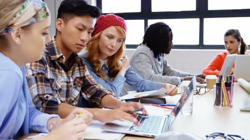 Diverse Team Collaborating on Project in Modern Office