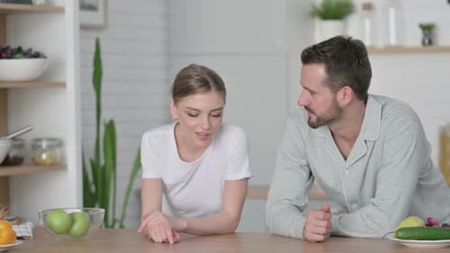Close Up of Young Couple Having Conversation While in Kitchen