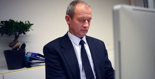 Senior Businessman Working In Office