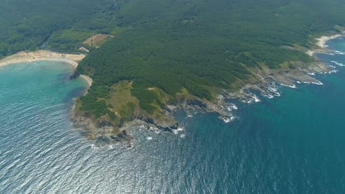 Rocky Coastline with Crop Fields. Waves Crashing Against Cliffs