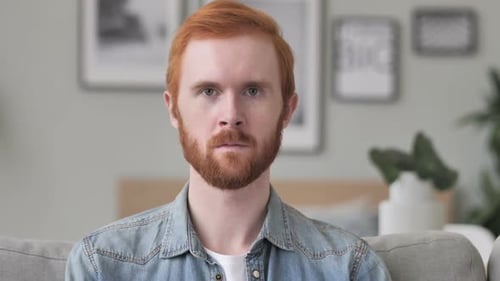 Portrait of Serious Man Looking at Camera