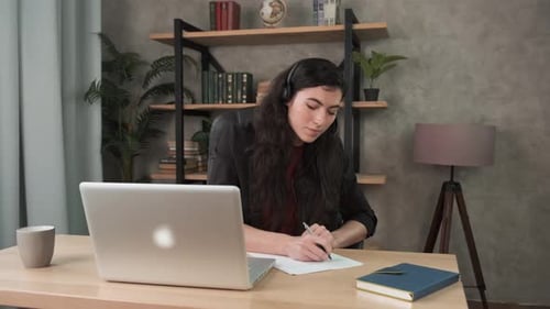 Woman Working from Home on Laptop with Headset
