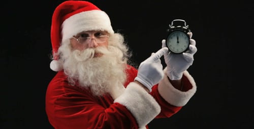 Santa Claus Points to Clock on Black Background