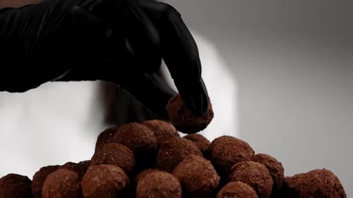 Hand Selecting Delicious Chocolate Truffle Candy