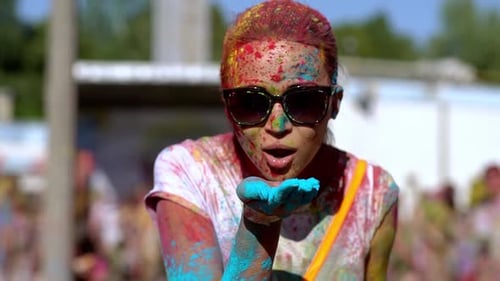 Woman Blowing Holi Powder at Festival Celebration