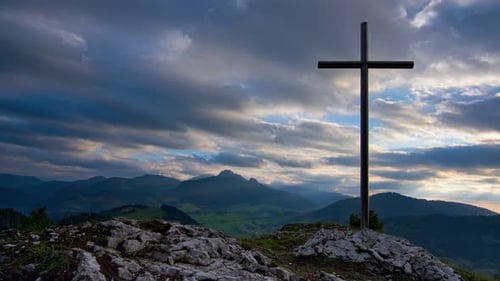 Christian cross on a rock,Beautiful mountain landscape with colorful thick clouds