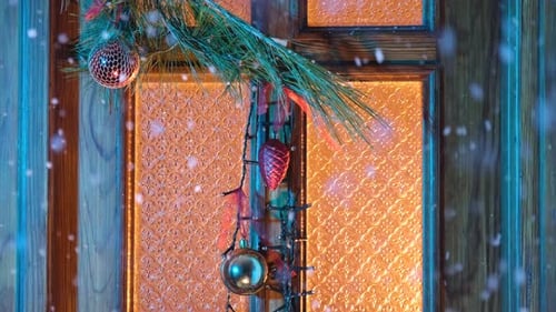Decorated Door with Christmas Ornaments and Falling Snow