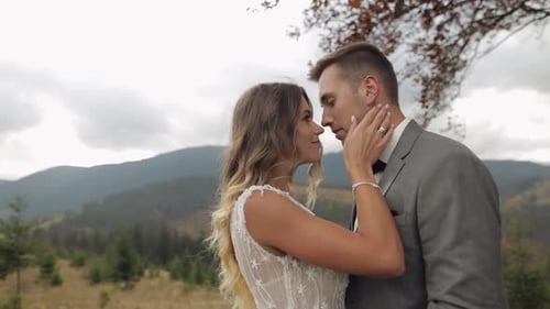 Lovely Young Newlyweds Bride Groom Embracing on Mountain Slope Holding Hands Wedding Couple Family