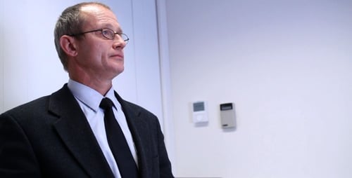 Senior Businessman Drinking Coffee In Office
