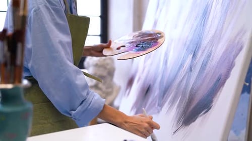 Woman Painting Abstract Art in a Bright Studio