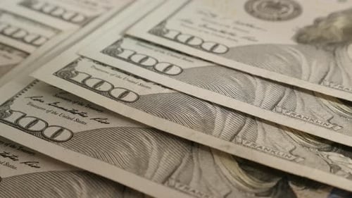 Slow tilt over hundred dollar banknotes in a row close-up 4K 2160p 30fps UltraHD footage - American