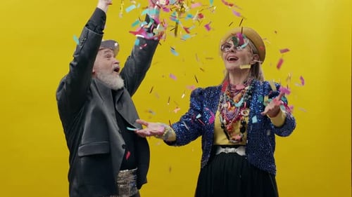Stylish Senior Couple Celebrating with Confetti