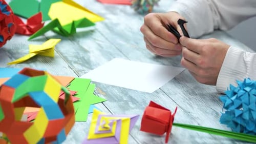 Man Creating Paper Origami Swan Art