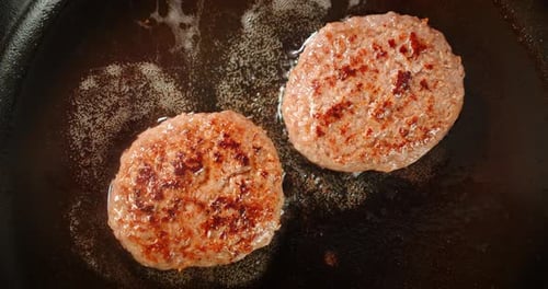 Cooking a Juicy Beef Burger in a Frying Pan.
