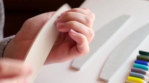 Woman Files Nails During a Manicure at Home