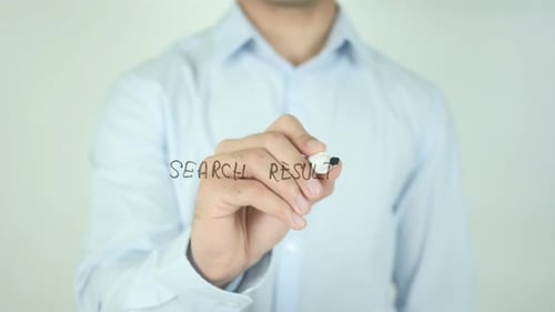 Man Writes 'Search Results' on Glass Surface