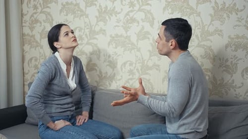 Couple Arguing on Couch at Home