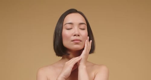 Young Asian Woman Demonstrates Perfect Skin After Treatment