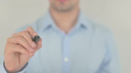 Adult Writing Question on Clear Surface with Pen