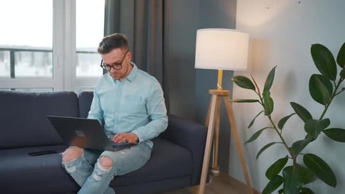 Man Working on Laptop in Modern Home Setting