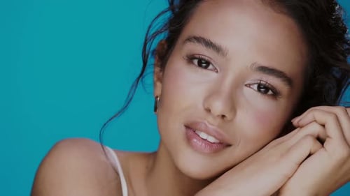 Beautiful Woman Posing with Hands Against Blue Background