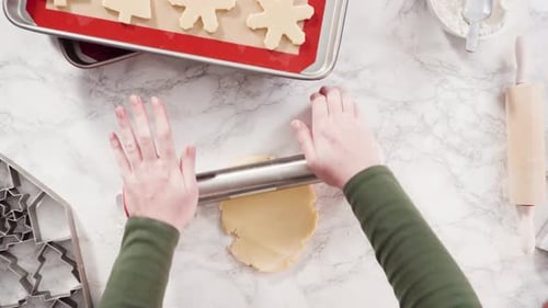 Flat lay. Step by step. Rolling out sugar cookie dough to bake Christmas cookies.