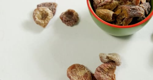 Dried fig in bowl placed on white surface 4K 4k
