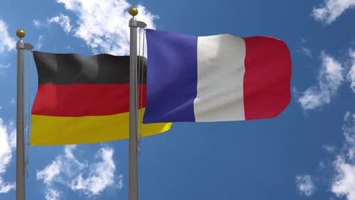 Germany and France National Flags Waving Together on Blue Sky