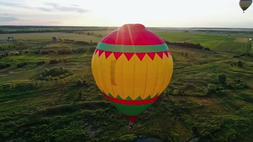 Hot Air Balloons Fly Over Green Countryside
