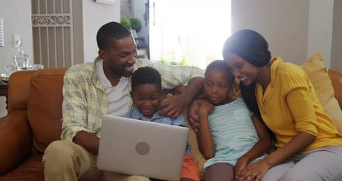Family using laptop in living room 4k
