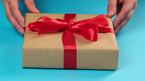 Festive Gift with Red Ribbon on Blue Background