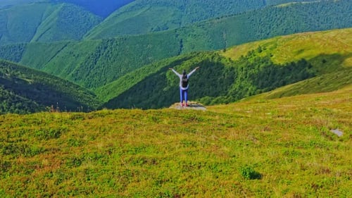 Woman Hiker Celebrates Success on Mountain Top