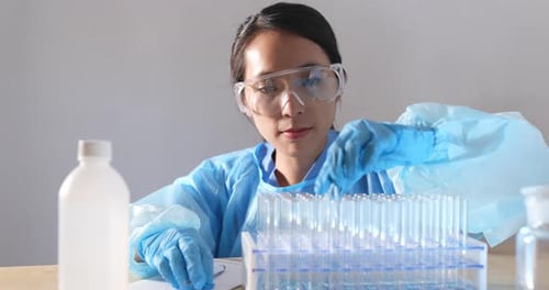 Woman Scientist Examining Test Tube in Lab