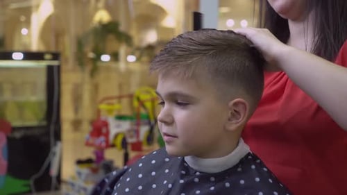 Boy Getting a Haircut at a Hair Salon