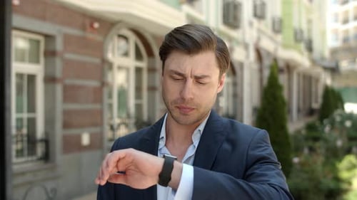Closeup Man Waiting for Partner at Street. Guy Checking Time on Smart Watch