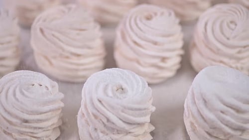 Marshmallows Sprinkled with Sugar Powder in Slow Motion