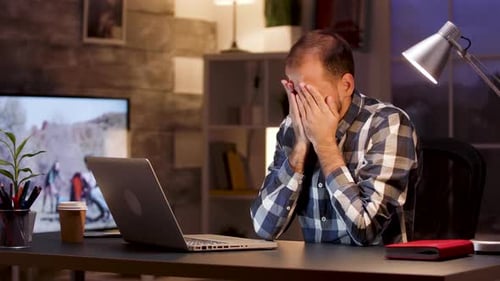 Tired Businessman Yawn and Rubbing Eyes in Home Office