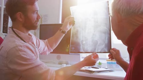 Doctor and Patient Reviewing X-Ray in Medical Office