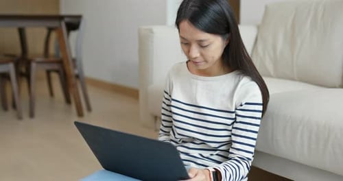 Woman Working on Laptop Computer in Living Room