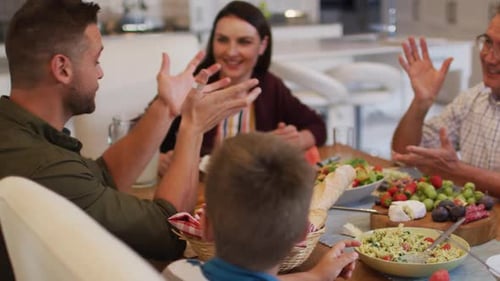 Family Gathered Around Dining Table Talking