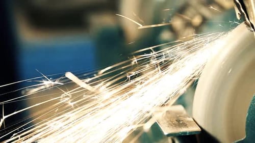 Close Up of Grinding Wheel Sending Sparks Flying