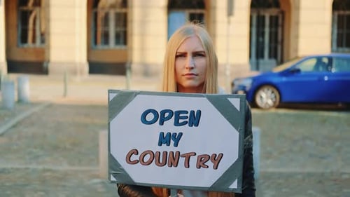 Une jeune femme appelle à ouvrir le pays lors d'une marche de protestation