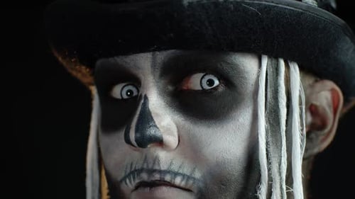 Close-up Shot of Creepy Man in Skeleton Halloween Makeup Opening Eyes and Looking Spooky at Camera