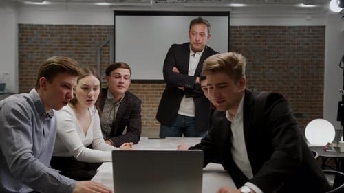 Colleagues Working Together Around Conference Table