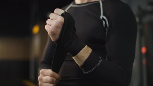Unrecognizable Man Ready for Fight at Gym. Boxer Wrapping Hands in Sport Club