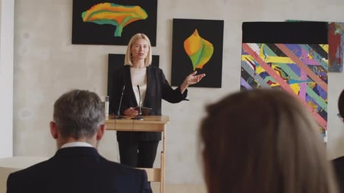 Woman Giving Presentation at Art Exhibition