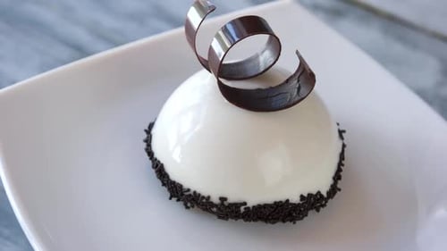 Petite Dessert Decorated with Chocolate on White Plate